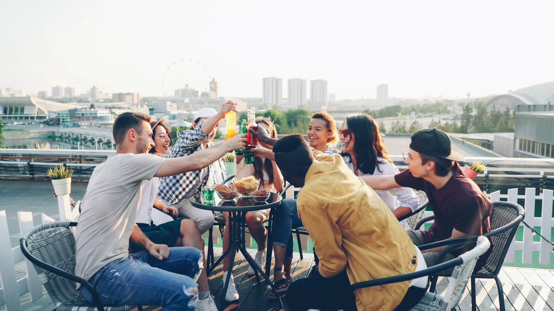 Grupo de amigos brindando en una terraza al atardecer